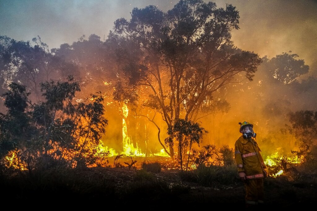 Australia fights bushfires in west, floods in east
