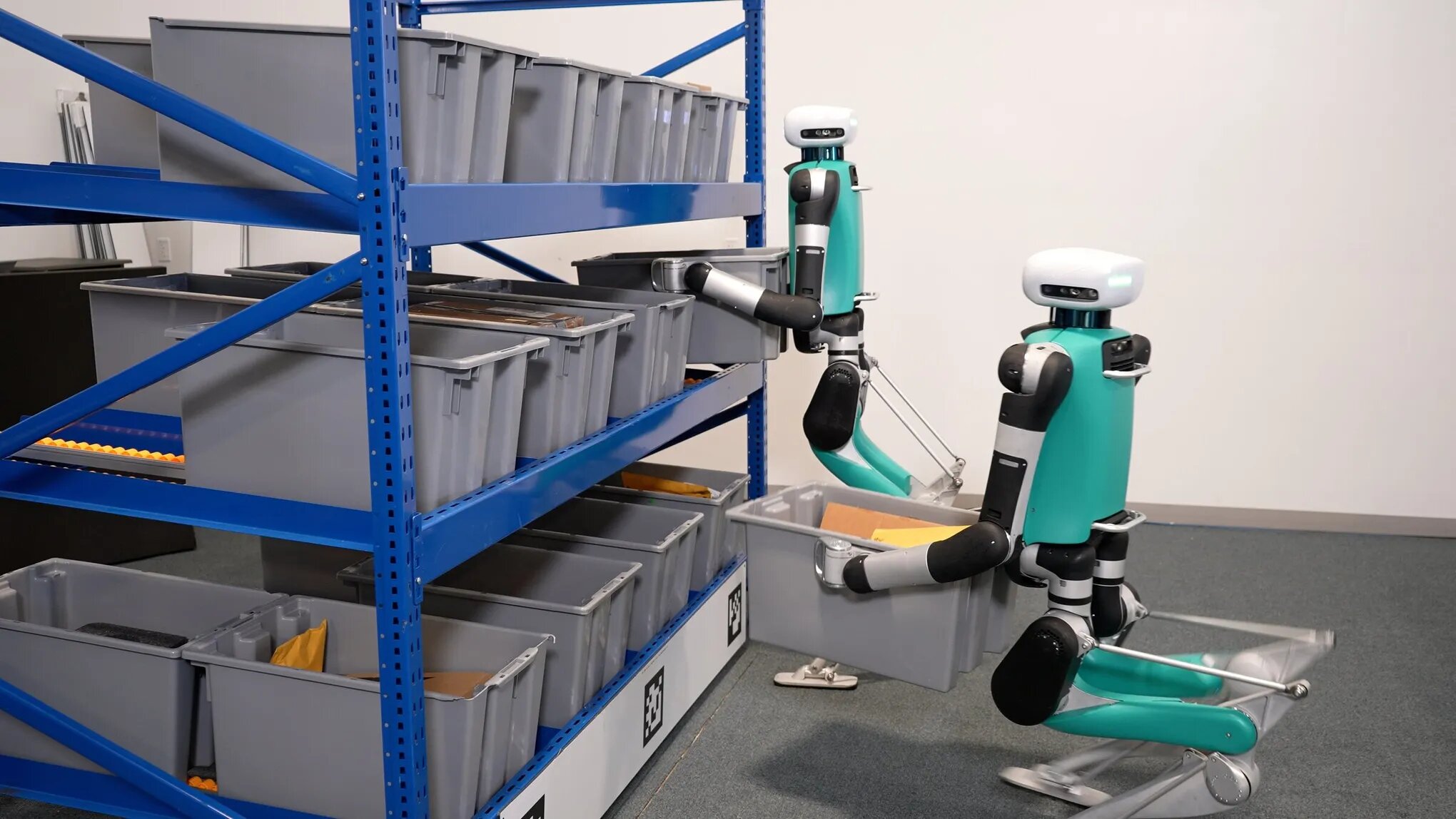 Robots organizing inventory bins at various heights.