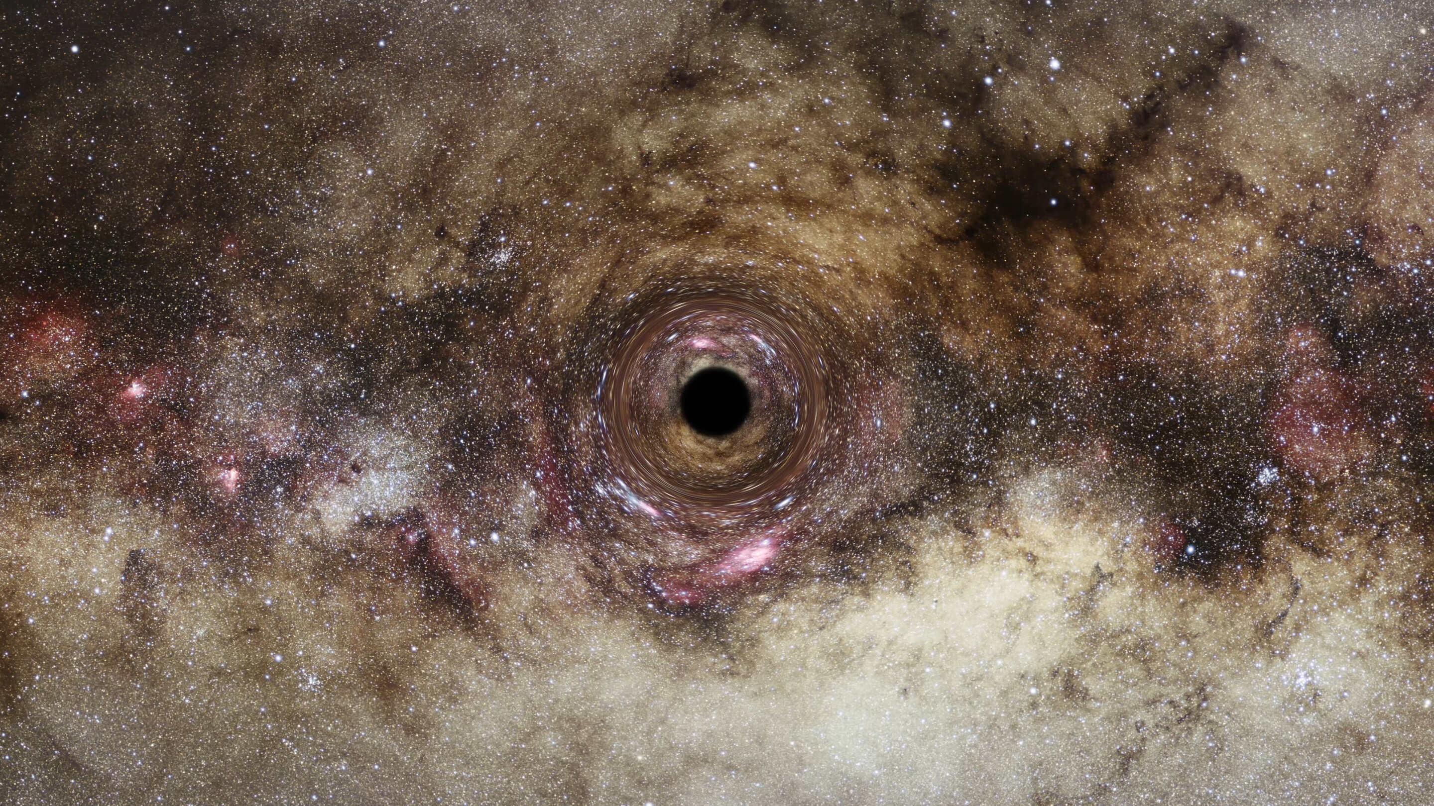 Pembengkokan cahaya gravitasi mengungkapkan salah satu lubang hitam terbesar yang pernah ditemukan